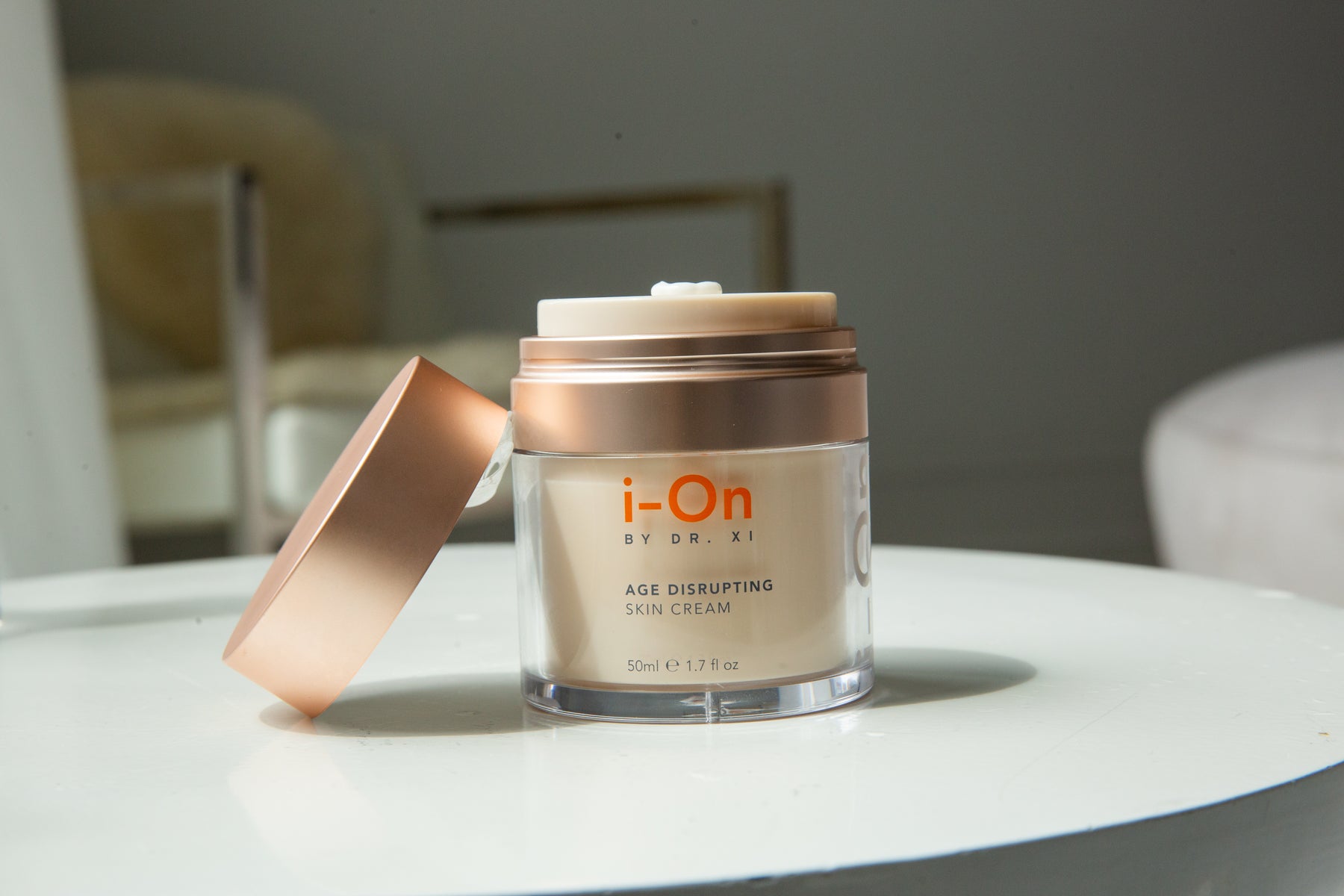 jar of skin cream with the top removed and leaning against the jar